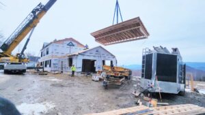 our team using a crane to build an ADU for a client