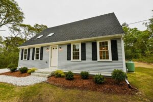 a beautiful, light blue ADU with a gray, shingled roof