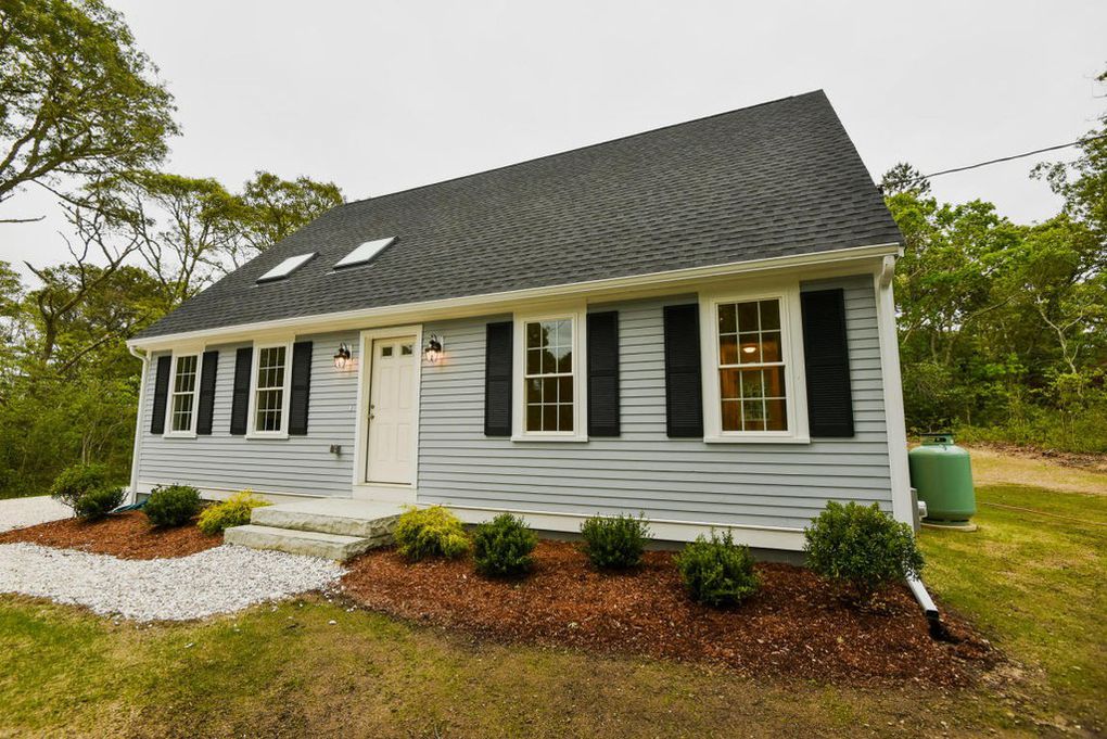a beautiful, light blue ADU with a gray, shingled roof